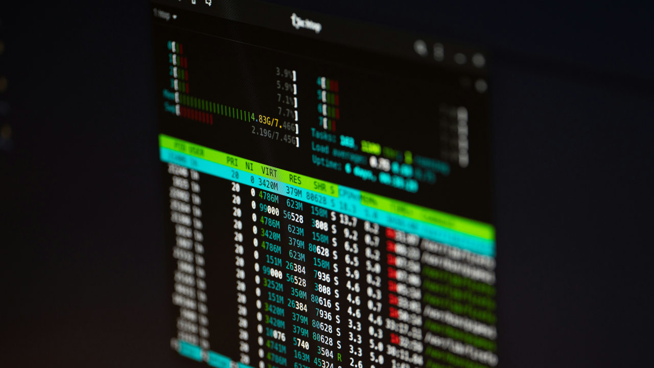 A photograph of a computer monitor displaying htop.