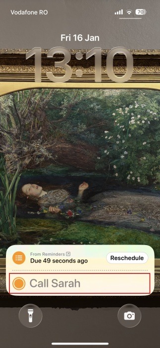 Reminder marked as "Done" via Live Activity on iPhone lock screen. 