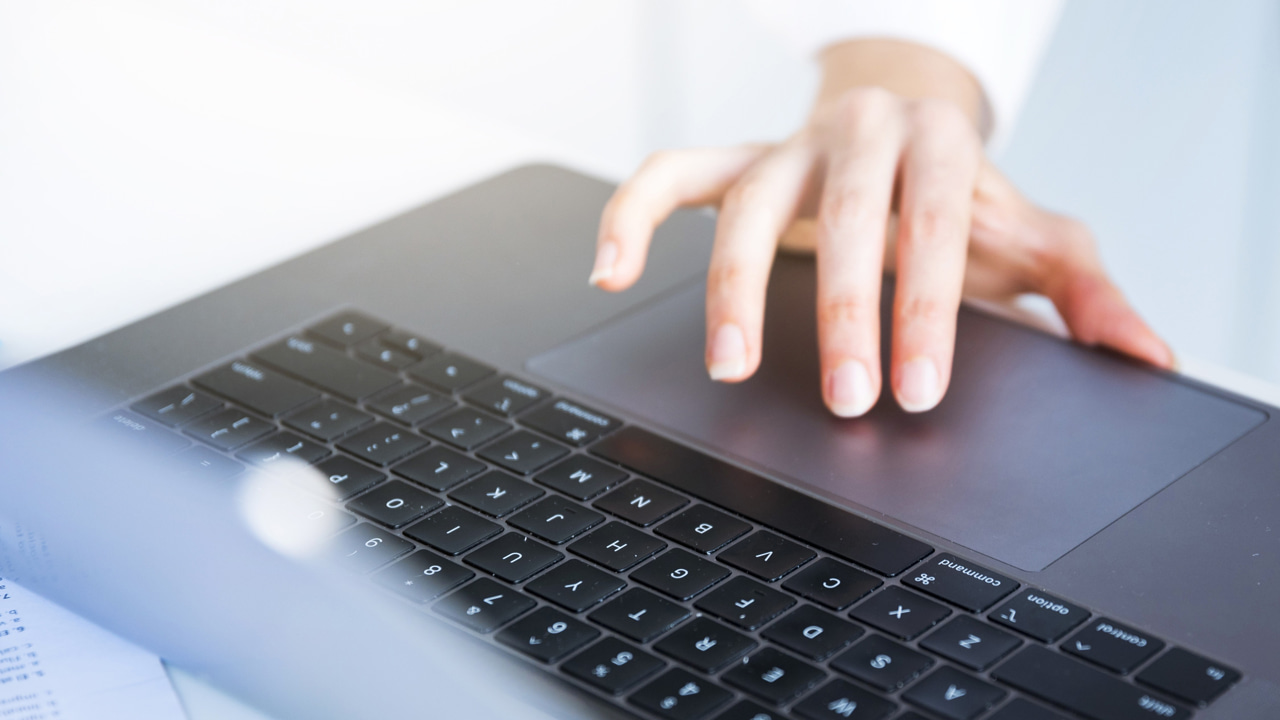 Hand on a laptop's touchpad