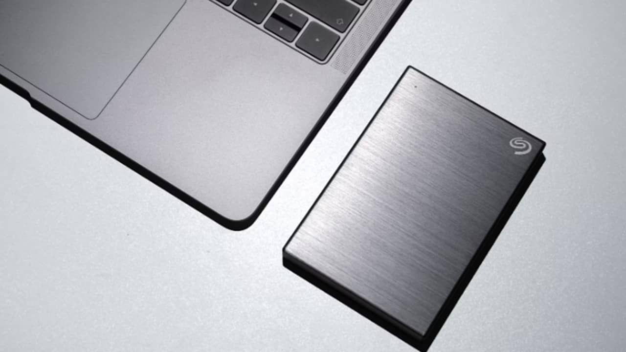 External hard drive next to laptop.