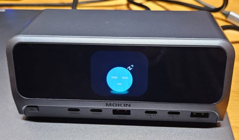 MOKiN docking station sitting on top of a laptop.