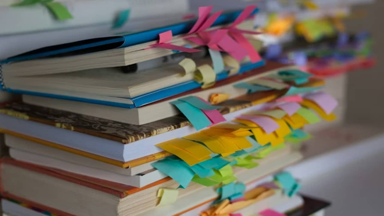 Stack of books with bookmarks.