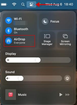 Clicking the Control Center icon on Mac.