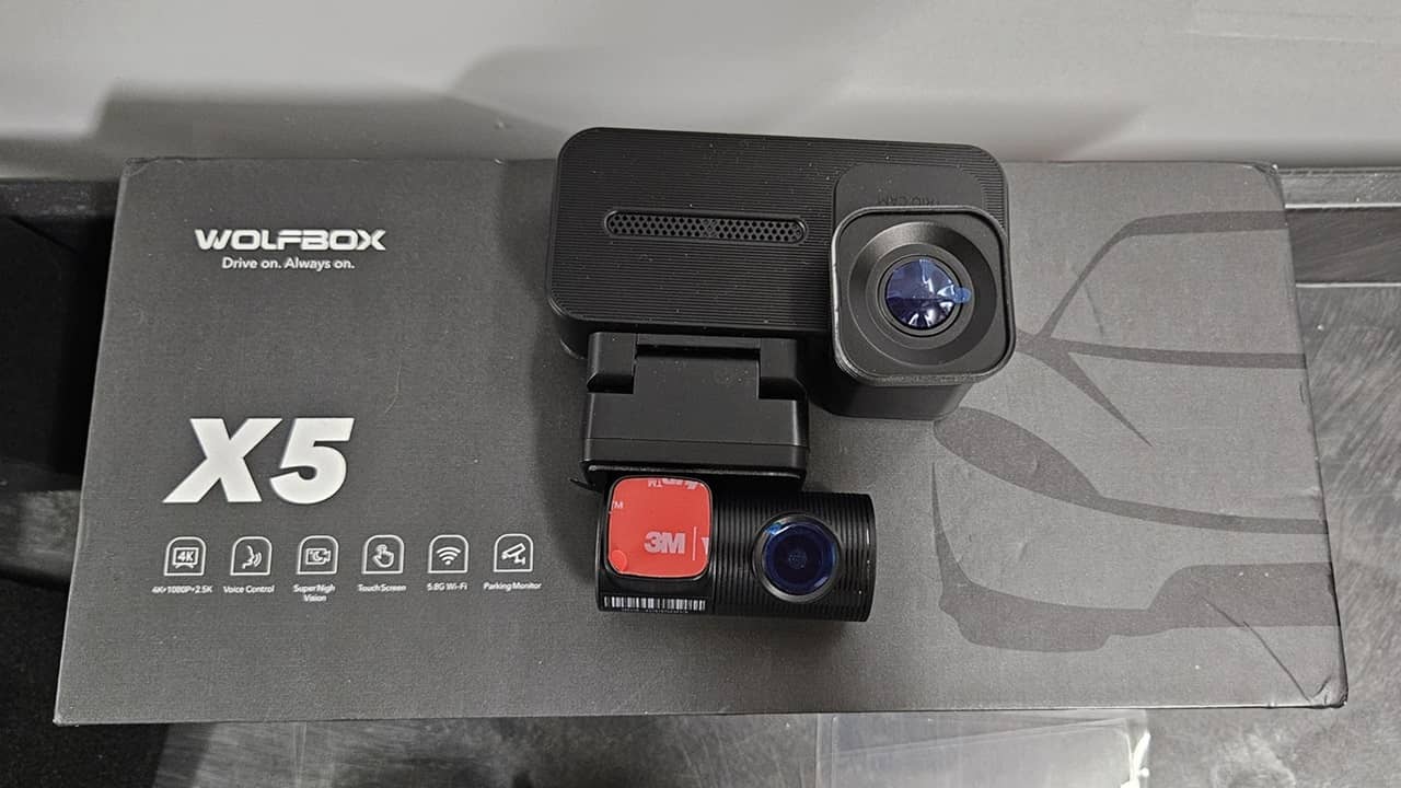 WolfBox X5 dash cam sitting on box.